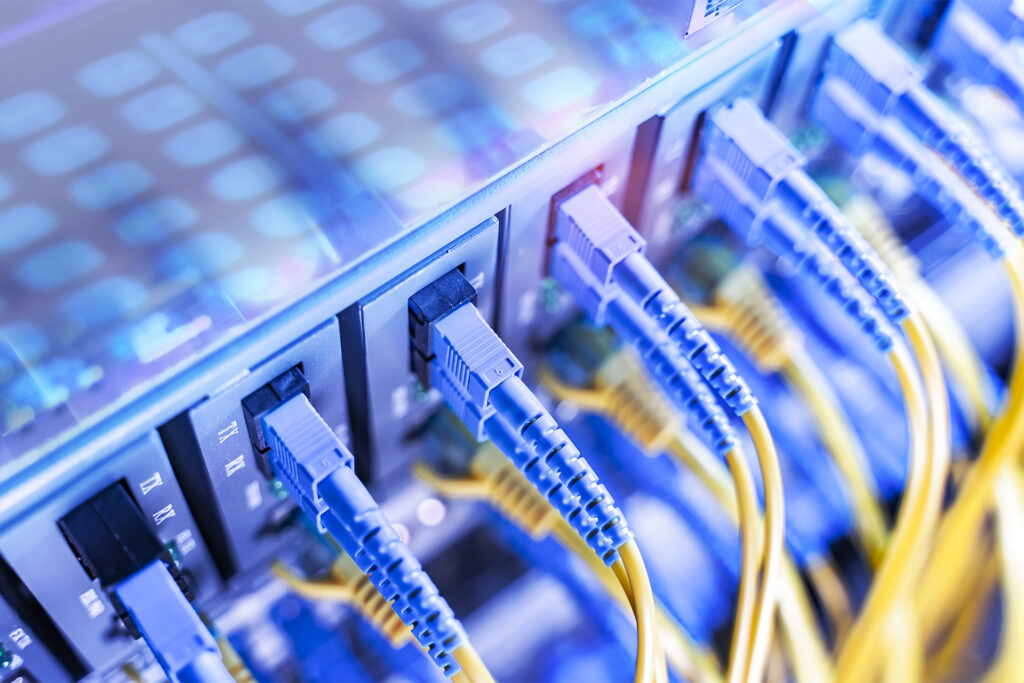 Fiber Optical cables connected to an optic ports and Network cables connected to ethernet ports
